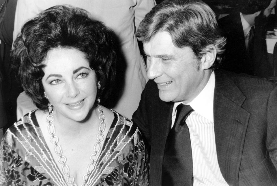 FILE - In this Jan. 30, 1977 file photo actress Elizabeth Taylor and her husband, former secretary of the U.S. Navy John Warner attend the 42nd New York Film Critics Circle Awards dinner in New York. Warner, one of the Senate’s most influential military experts, died Tuesday, May 25, 2021, at age 94, his longtime chief of staff said Wednesday, May 26. (AP Photo/File)