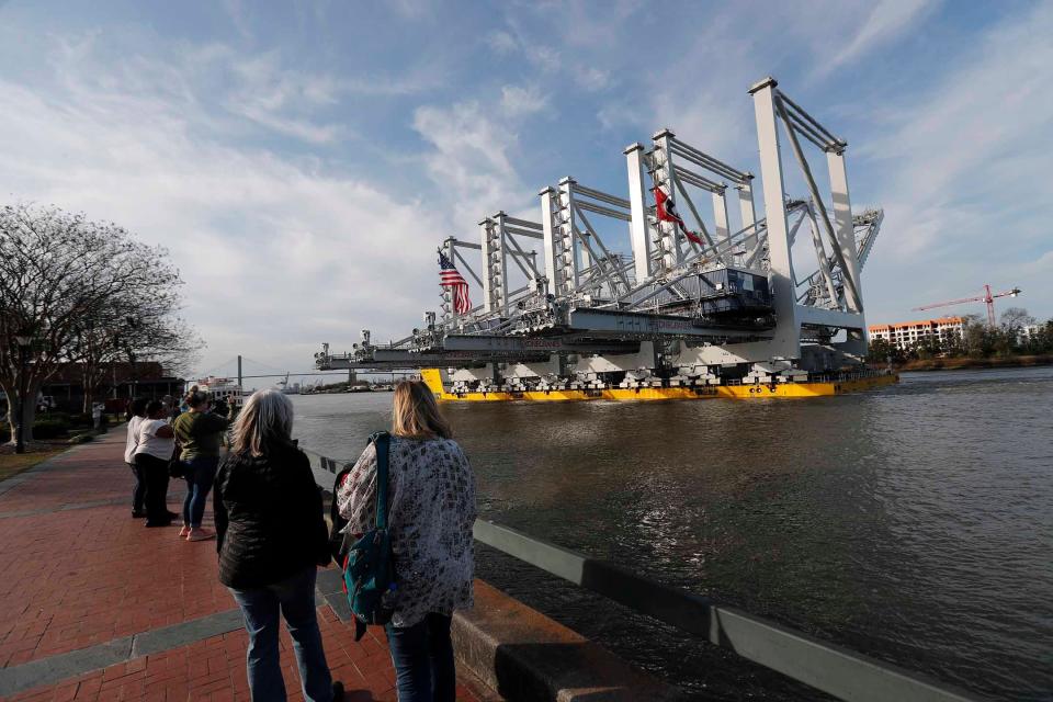 The Biglift Baffin passes River Street enroute to the Georgia Ports Authority Garden City Terminal with a load of large ship-to-shore cranes.