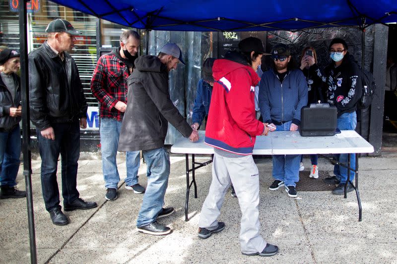 FILE PHOTO: Community members from the Drug User Liberation Front hand out clean, tested doses of drugs in Vancouver