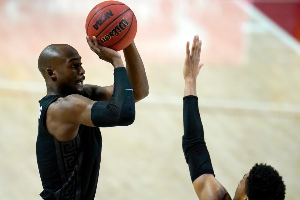 Michigan State guard Joshua Langford, left, shoots against Maryland guard Aaron Wiggins during the first half of an NCAA college basketball game, Sunday, Feb. 28, 2021, in College Park, Md.