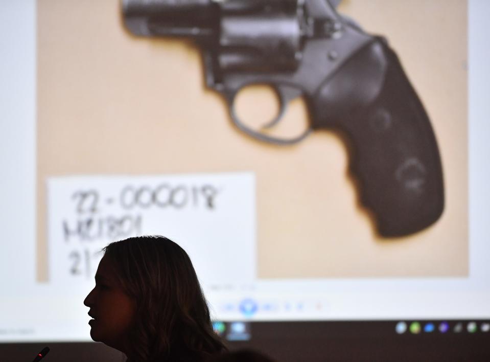 Sarasota Police Department crime scene investigator Marissa Zacarolli is silhouetted against a projected photograph of the gun as she testifies about processing the weapon allegedly used by LaToya Johnson on New Years Day 2022. Johnson is standing trial for the murder of Alain Sierra at Patellini's Pizza on Main St. in downtown Sarasota on New Year's Day 2022.