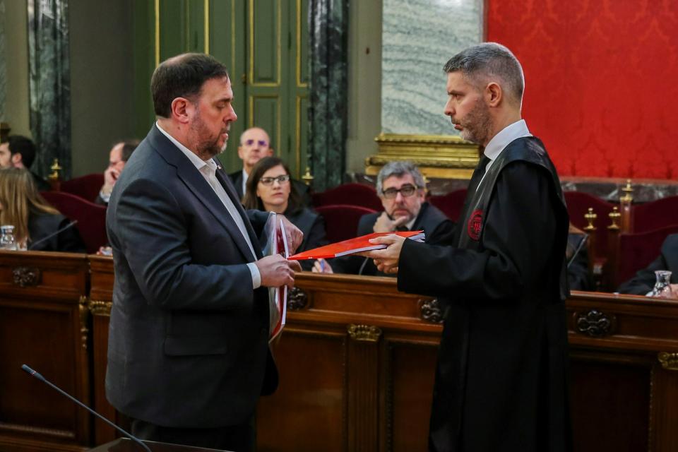 Catalan regional Vice-President, Oriol Junqueras, left, speaks with his lawyer Andreu Van Den Eynde, during the trial at the Spanish Supreme Court in Madrid, Tuesday, Feb. 12, 2019. Spain is bracing for the nation's most sensitive trial in four decades of democracy this week, with a dozen Catalan separatists facing charges including rebellion over a failed secession bid in 2017. (Emilio Naranjo/Pool via AP)