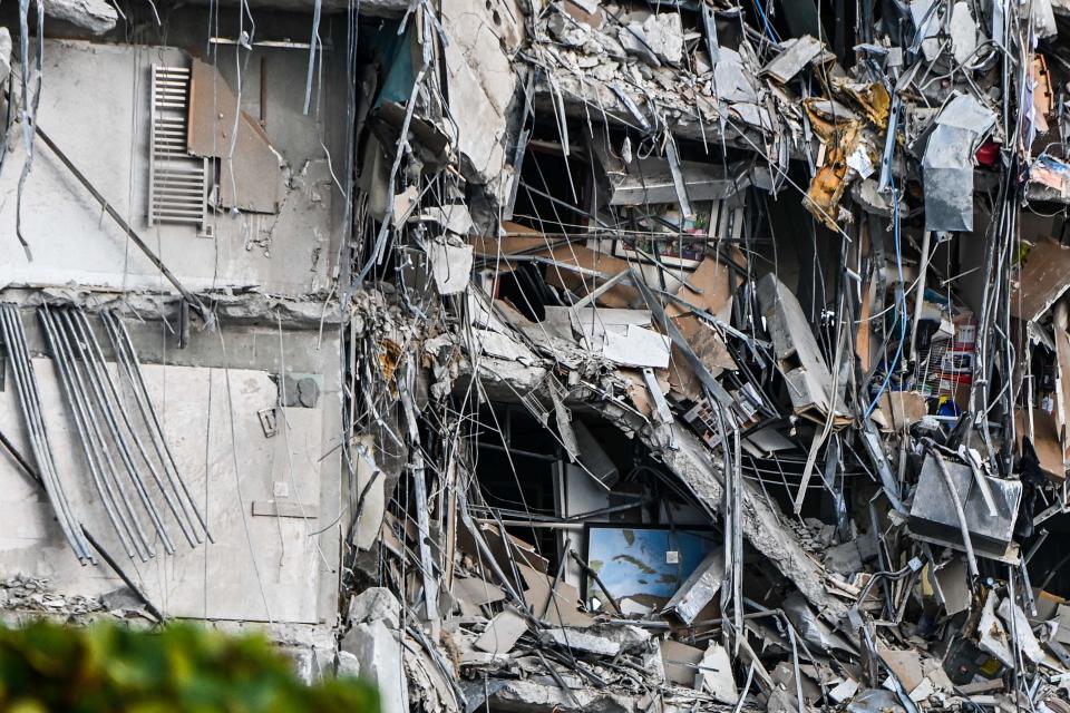 Rubble hangs from a partially collapsed building in Surfside north of Miami Beach, on June 24, 2021.