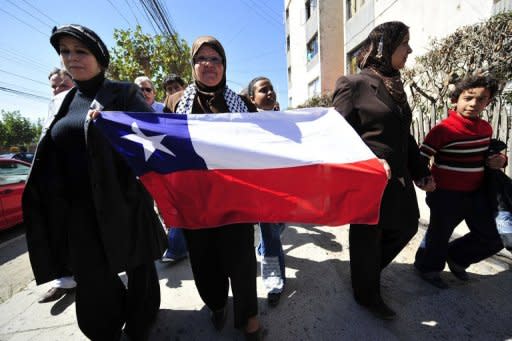 Newly arrived Palestine refugees deploy a Chilean banner as residents of La Calera, 130 kilometres north of Santiago, Chile gather to welcome them in 2008. In just over a century, Chile's Palestinian community has achieved things still not possible at home: a widespread rise to prosperity, elite status and even their own football team