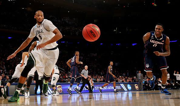 Adreian Payne #5 of the Michigan State Spartans and Phillip Nolan #0 of the Connecticut Huskies chase after a loose ball during the East Regional Final of the 2014 NCAA Men's Basketball Tournament at Madison Square Garden on March 30, 2014 in New York City.  (Photo by Bruce Bennett/Getty Images)