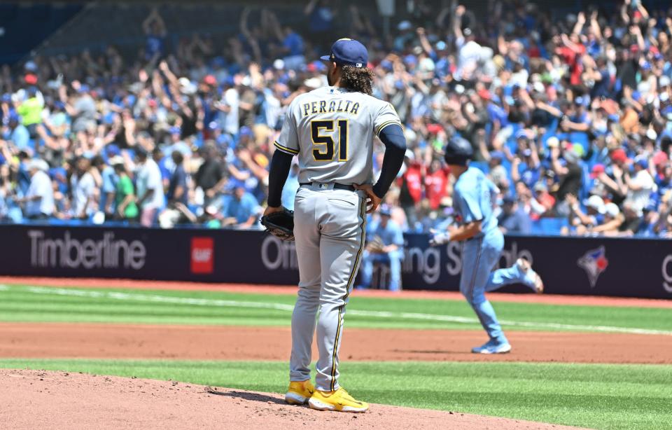 Brewers starting pitcher Freddy Peralta watches Blue Jays third baseman Matt Chapman round the bases after hitting a two-tun home run in the first inning Thursday.