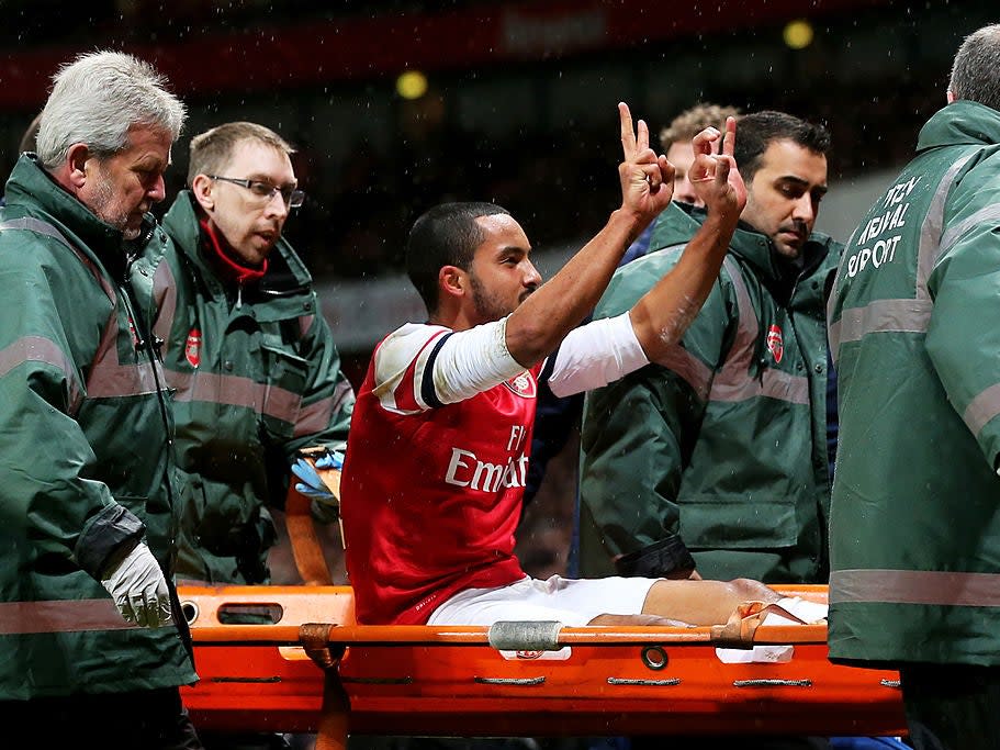 <p>Theo Walcott is taken off on a stretcher during the North London derby in 2014</p>Getty Images