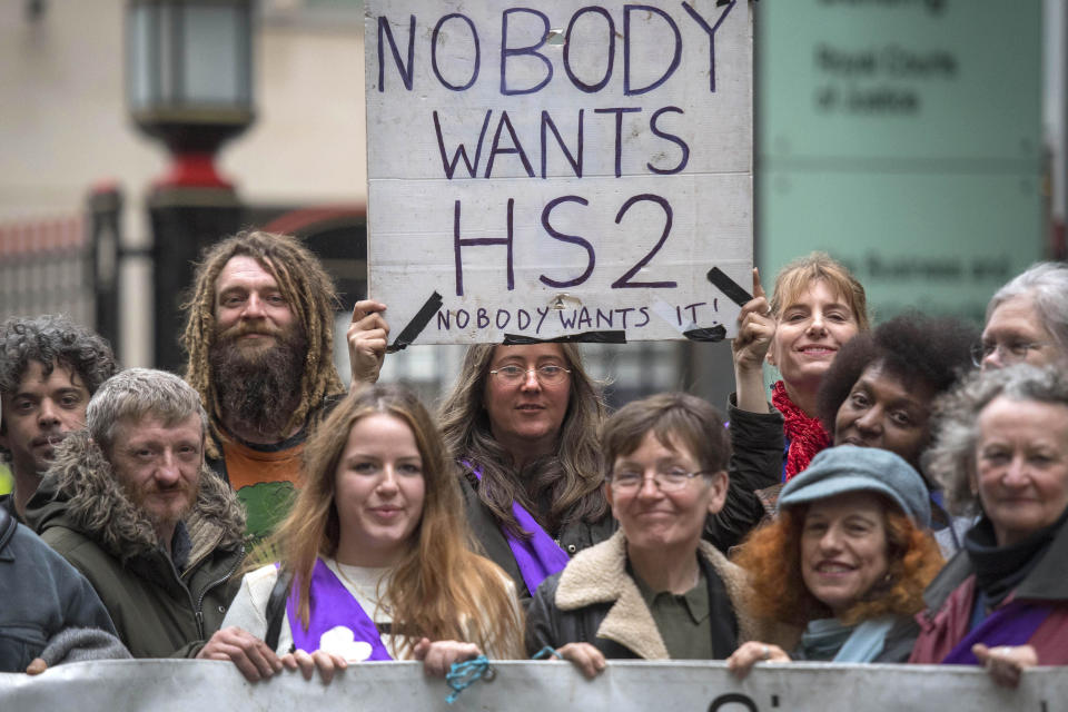 Protesters hold a banner outside the Rolls Building in central London, as Transport Secretary Chris Grayling launches High Court action in a bid to stop 'unlawful protest' by demonstrators opposed to the HS2 rail line running through a woodland area in west London.