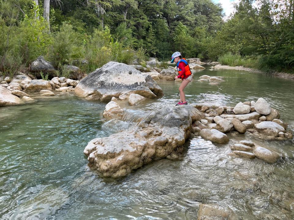 Saba Khonsari's child playing in the river at Garner State Park