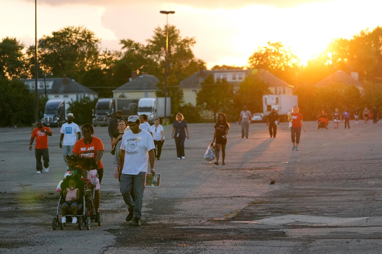 Linden Community & Columbus Ohio Stop The Violence walk a neighborhood behind the Northern Lights shopping center on Sept. 19, shouting messages about stopping gun violence and bringing the Linden community together. The Facebook group was created by Linden community advocate Derrick Russell, a former gang leader of the Short North Posse and convicted drug dealer who has been out of prison for 15 years.