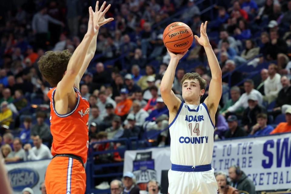 Connor Loy (14) got off a shot over Marshall County’s Kaden Mohler on Wednesday night. Loy scored 11 points and led Adair County with eight assists while committing no turnovers.