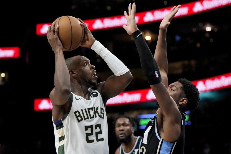 Milwaukee Bucks forward Khris Middleton (22) shoots against Atlanta Hawks guard Trent Forrest (2) during the second half of an NBA basketball game, Saturday, March 30, 2024, in Atlanta. (AP Photo/Mike Stewart)