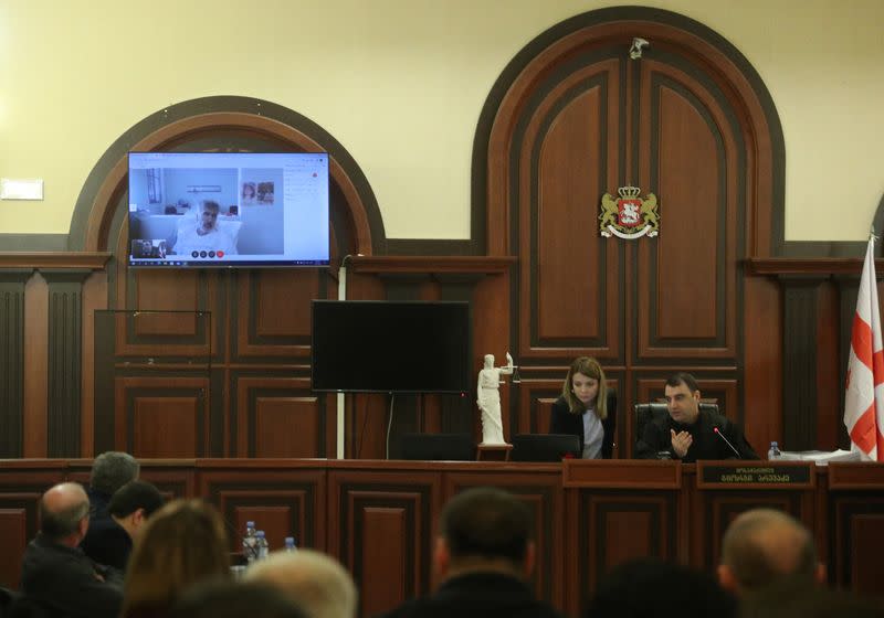 Georgia's jailed ex-President Mikheil Saakashvili is seen on a screen during a court hearing in Tbilisi