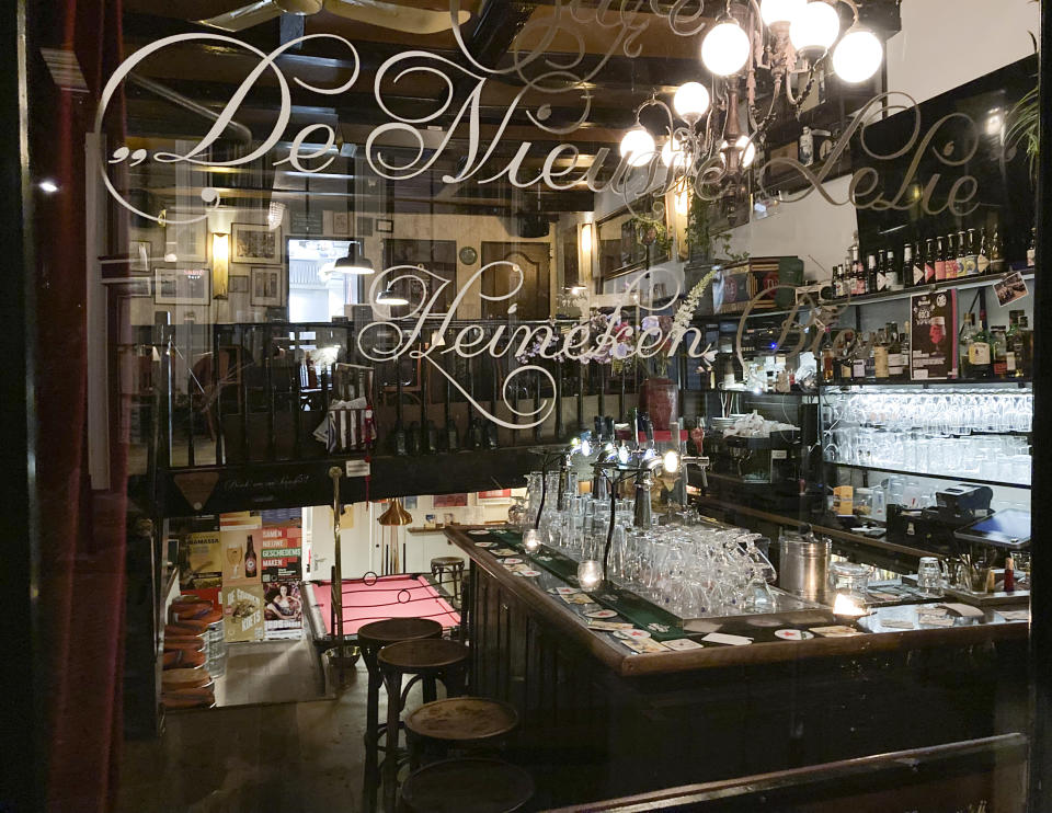 Café De Nieuwe Lelie closed at 5pm in Amsterdam, Netherlands, Sunday, Nov. 28, 2021, as a tougher COVID-19 related lockdown came into effect starting 5 pm, moving closing time forward three hours amid swiftly rising infections and ICU admissions. (AP Photo/Mike Corder)