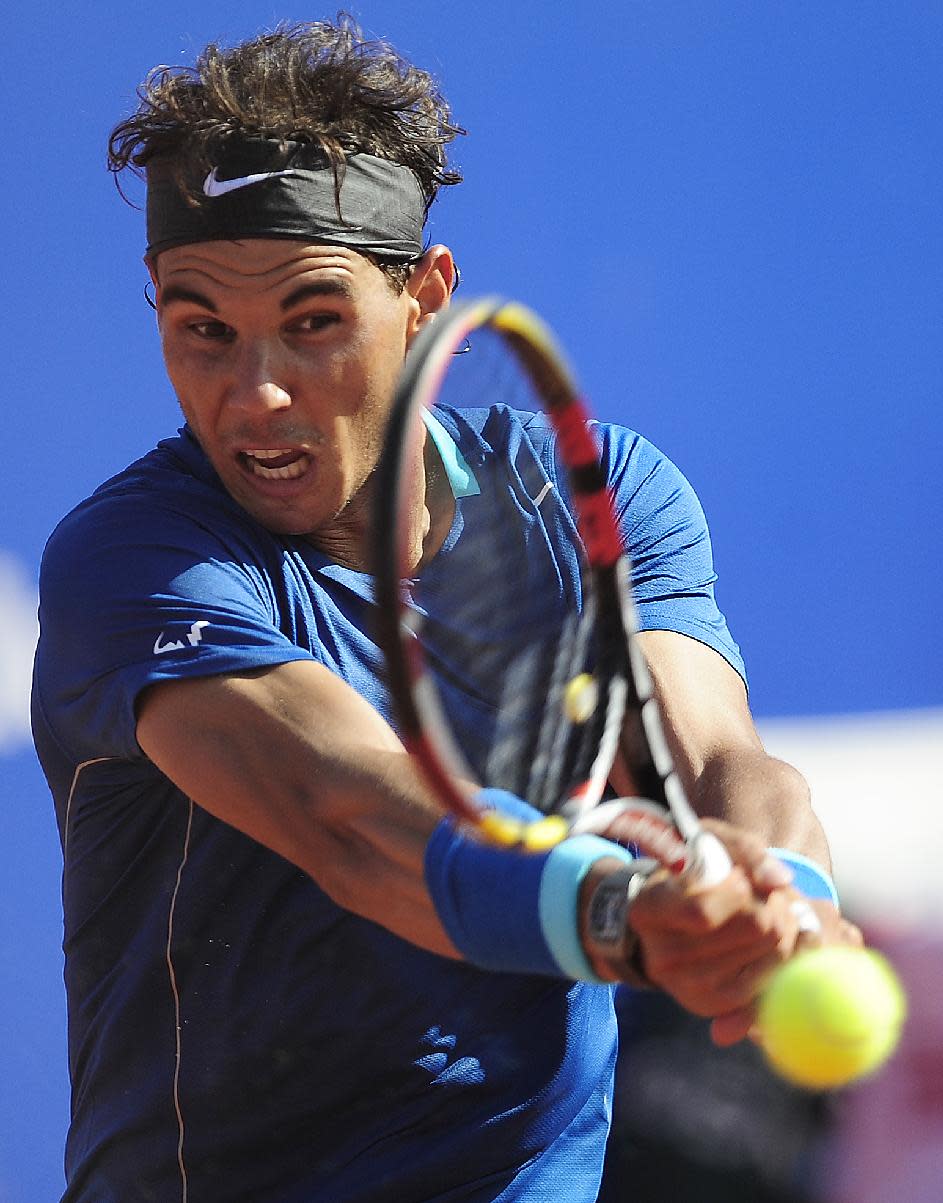 Rafael Nadal returns the ball to Albert Ramos during the Barcelona open tennis in Barcelona, Spain, Wednesday, April 23, 2014. (AP Photo/Manu Fernandez)