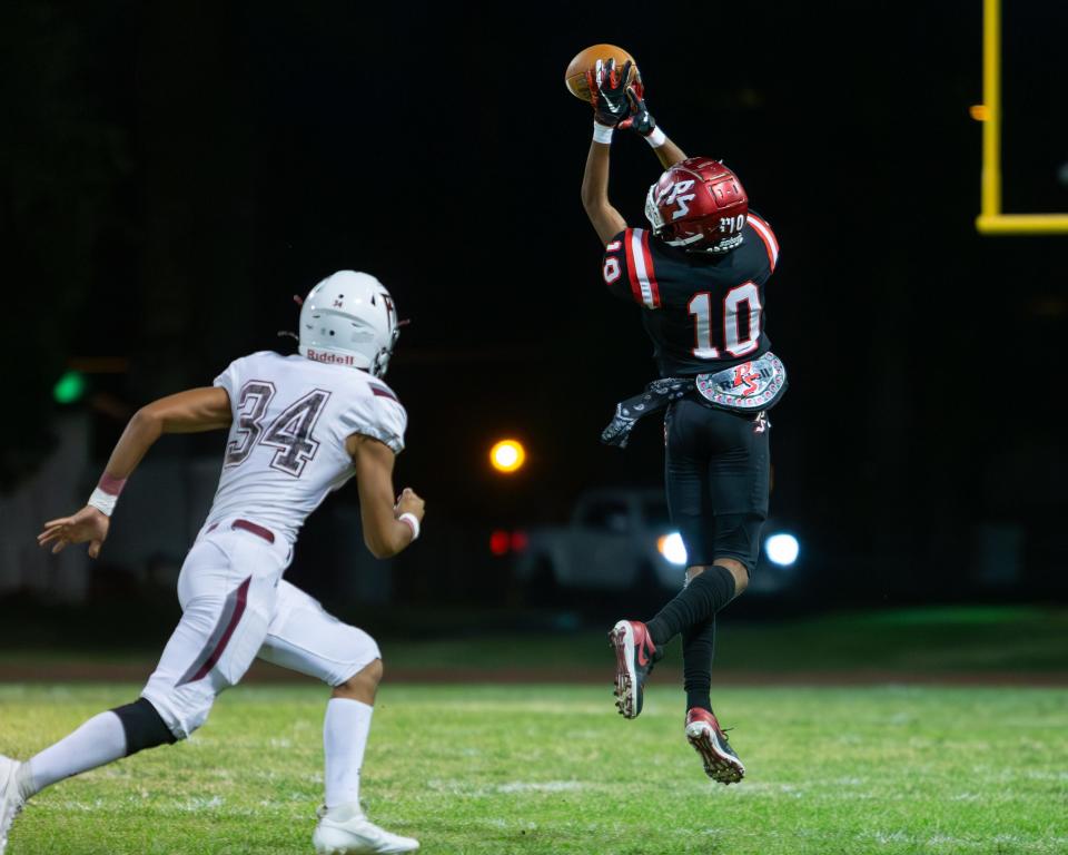 Damonte Lee of Palm Springs hauls in a pass as Rancho Mirage's Erik Beltran defends in the high school football game between Palm Springs and Rancho Mirage on Sept. 29, 2023.