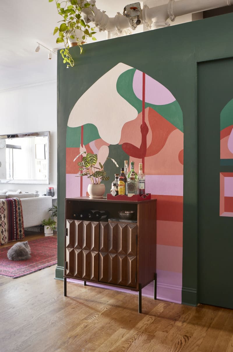 Bar credenza in front of colorful mural.