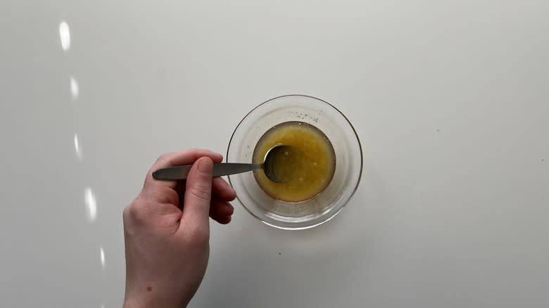 hand stirring syrup in bowl