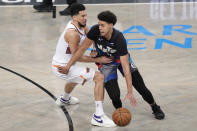 Brooklyn Nets forward Cameron Johnson (2) drives against Phoenix Suns guard Devin Booker (1) during the first half of an NBA basketball game, Wednesday, Jan. 31, 2024, in New York. (AP Photo/Mary Altaffer)