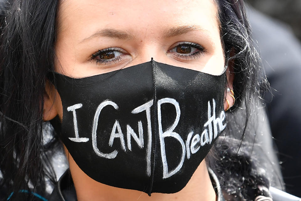 A protester wearing PPE (personal protective equipment) of a face mask as a precautionary measure against COVID-19, attends a demonstration in Manchester, northern England, on June 6, 2020, to show solidarity with the Black Lives Matter movement in the wake of the killing of George Floyd, an unarmed black man who died after a police officer knelt on his neck in Minneapolis. - The United States braced Friday for massive weekend protests against racism and police brutality, as outrage soared over the latest law enforcement abuses against demonstrators that were caught on camera. With protests over last week's police killing of George Floyd, an unarmed black man, surging into a second weekend, President Donald Trump sparked fresh controversy by saying it was a "great day" for Floyd. (Photo by Paul ELLIS / AFP) (Photo by PAUL ELLIS/AFP via Getty Images)
