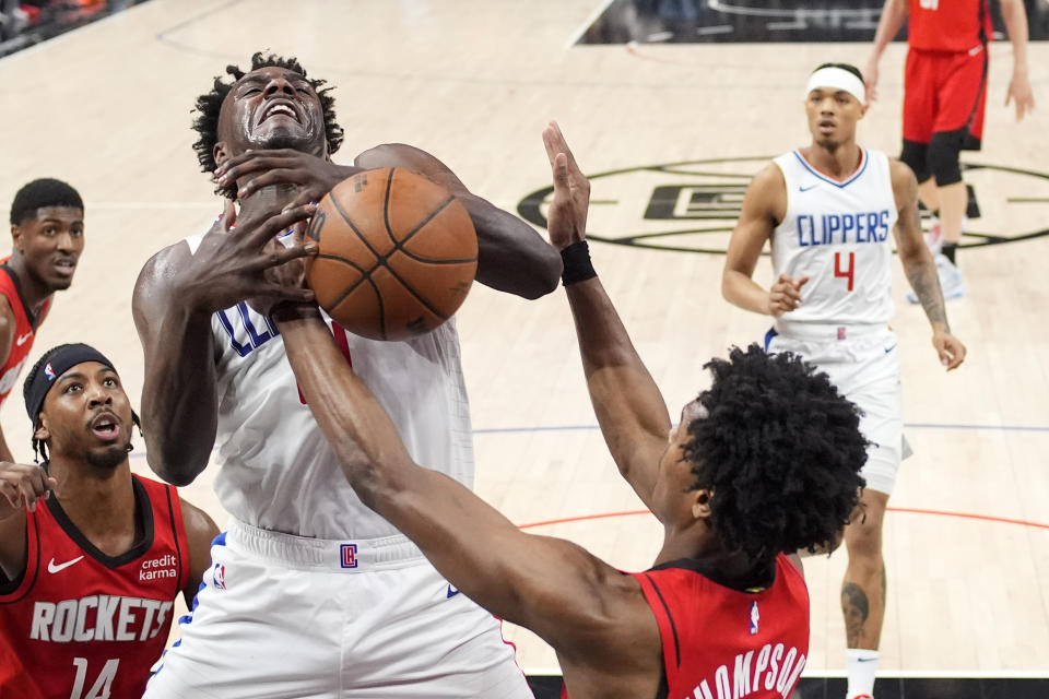 Los Angeles Clippers guard Kobe Brown, center, has the ball knocked from his hands by Houston Rockets forward Amen Thompson, second from right, during the second half of an NBA basketball game Sunday, April 14, 2024, in Los Angeles. (AP Photo/Mark J. Terrill)