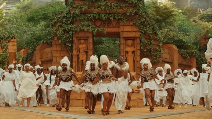 A tribe of Wakandans dance
