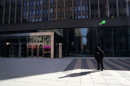 A security guard stands outside a closed federal building in the Manhattan borough of New York City, New York, U.S., January 15, 2019. REUTERS/Carlo Allegri