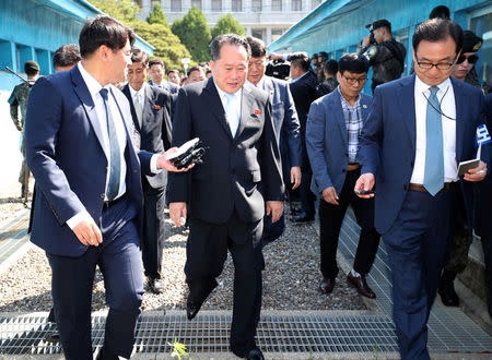 Ri Son Gwon, chairman of the Committee for the Peaceful Reunification of the Country crosses the concrete border to attend a meeting with South Korean Unification Minister Cho Myoung-gyon at the truce village of Panmunjom, South Korea, June 1, 2018. Yonhap via REUTERS