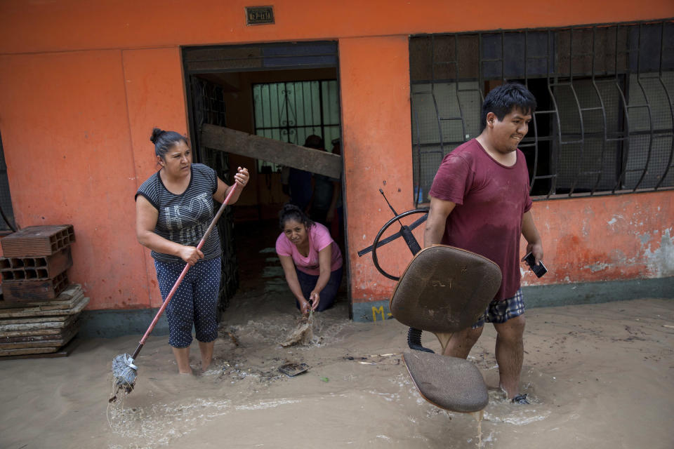 Neighbors work to salvage belongings from their flooded homes in Lima, Peru, Thursday, March 16, 2017. A new round of unusually heavy rains has killed at least a dozen people in Peru and now threatens flooding in the capital. Authorities said Thursday they expect the intense rains caused by the warming of surface waters in the eastern Pacific Ocean to continue another two weeks. (AP Photo/Rodrigo Abd)