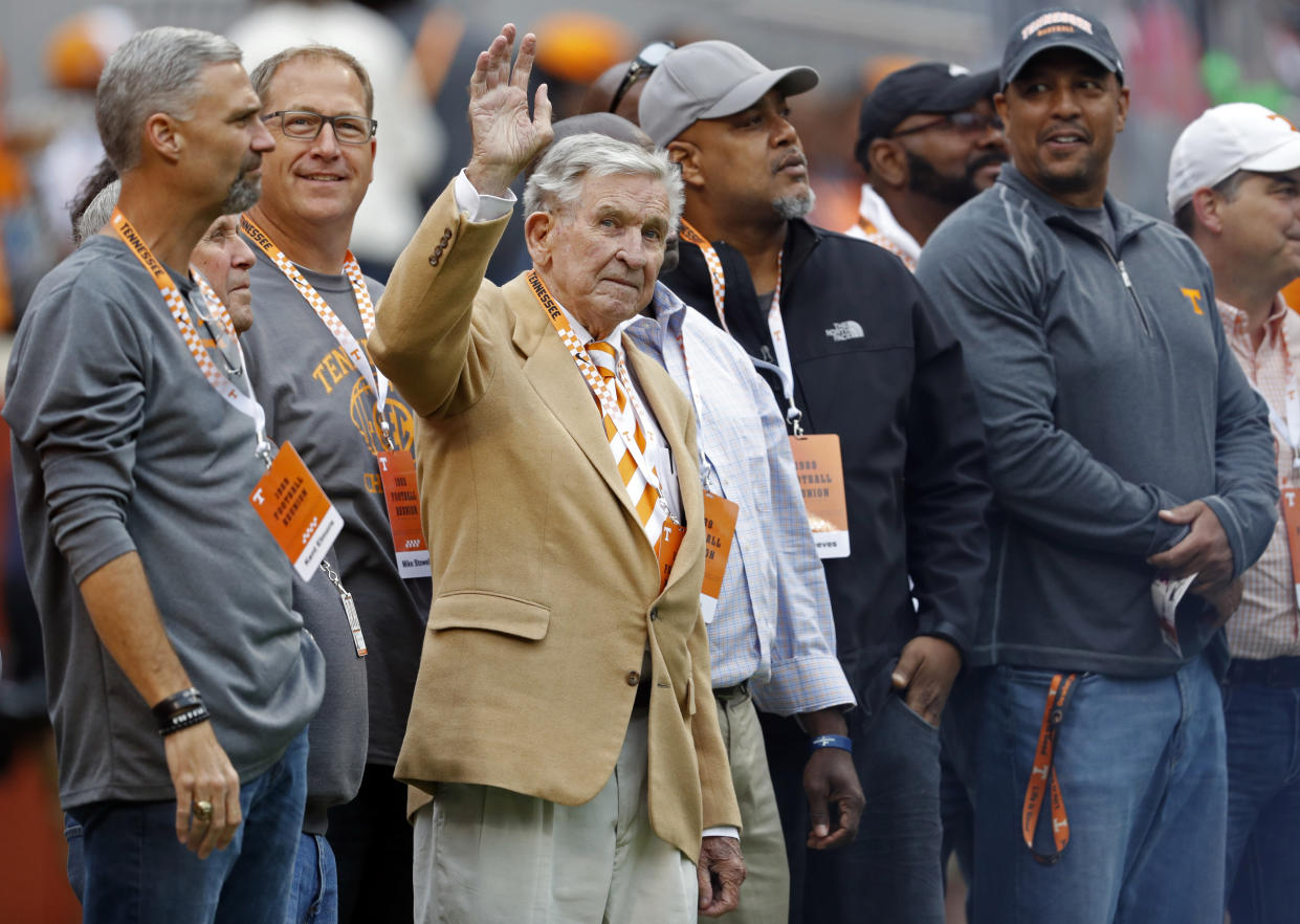 Former Tennessee head football coach Johnny Majors waves to fans as he and members of the 1998 football team are introduced in the first half of an NCAA college football game against Mississippi State, Saturday, Oct. 12, 2019, in Knoxville, Tenn. (AP Photo/Wade Payne)