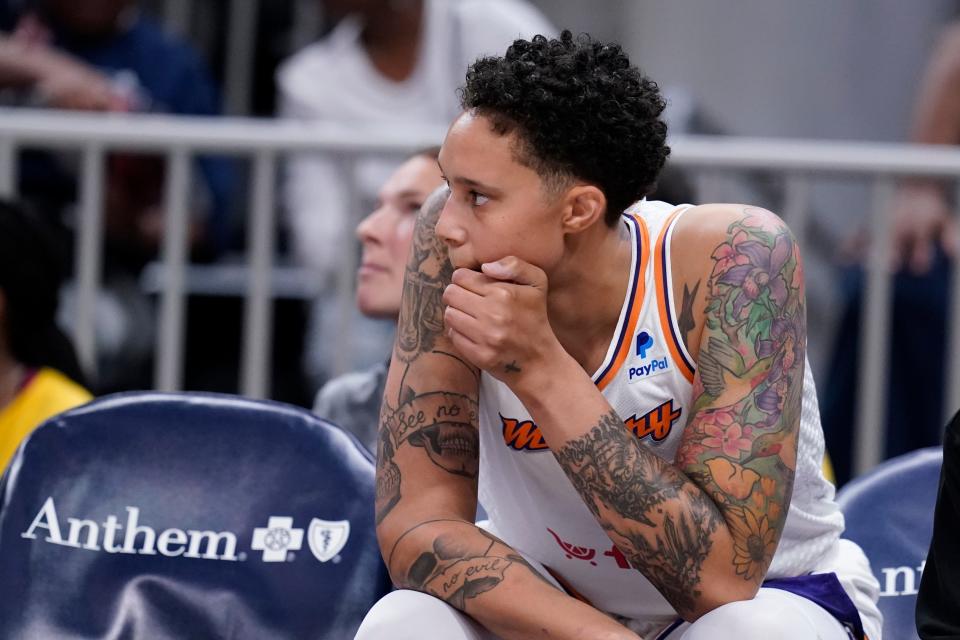 Phoenix Mercury's Brittney Griner watches from the bench during the first half of a WNBA basketball game against the Indiana Fever on June 11, 2023, in Indianapolis.