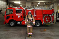 <p>Ran Namise, 24, a firefighter belonging to the command squad, poses in front of a fire engine at Kojimachi Fire Station in Tokyo on February 23, 2018. (Photo: Kazuhiro Nogi/AFP/Getty Images) </p>