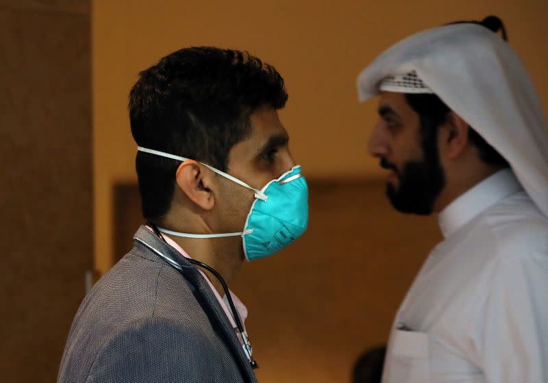 A vistor wears a mask during the Arab Health Exhibition in Dubai