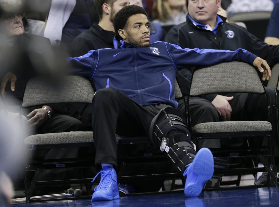 Creighton's Maurice Watson Jr., out for the season due to a torn ACL, sits on the bench during the second half of an NCAA college basketball game against Marquette in Omaha, Neb., Saturday, Jan. 21, 2017. Marquette won 102-94. (AP Photo/Nati Harnik)