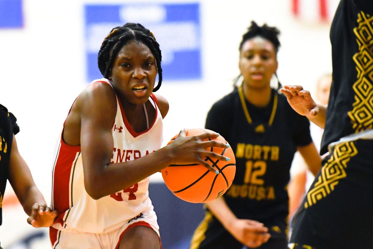 Wade Hampton's Quinasia Abercrombie (24) takes the ball to the hood during the Upper State finals against North Augusta on Friday, Feb. 22, 2023 at Bob Jones University. 