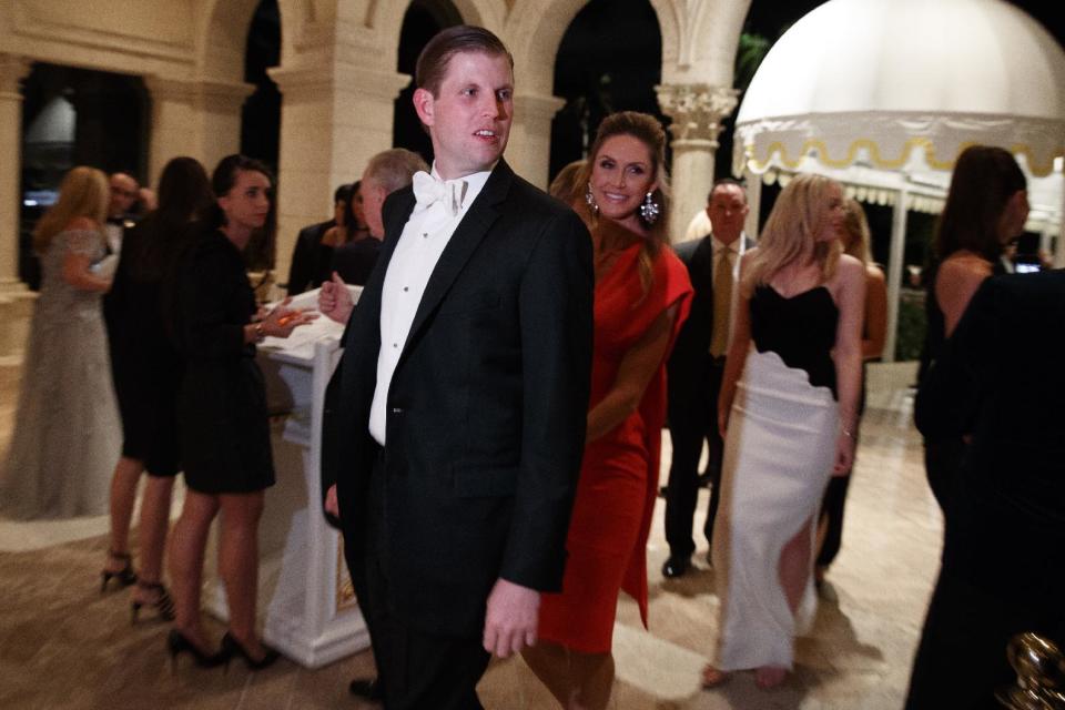 Eric Trump, left, and his wife Lara Yunaska arrive for a New Years Eve party at Mar-a-Lago, Saturday, Dec. 31, 2016, in Palm Beach, Fla. (AP Photo/Evan Vucci)