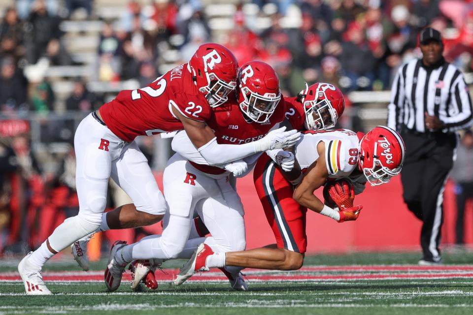 Maryland Terrapins wide receiver Carlos Carriere (83) is tackled by Rutgers Scarlet Knights defensive back Avery Young (2) and linebacker Tyreek Maddox-Williams (9) and linebacker Tyreem Powell (22) during the first half at SHI Stadium.