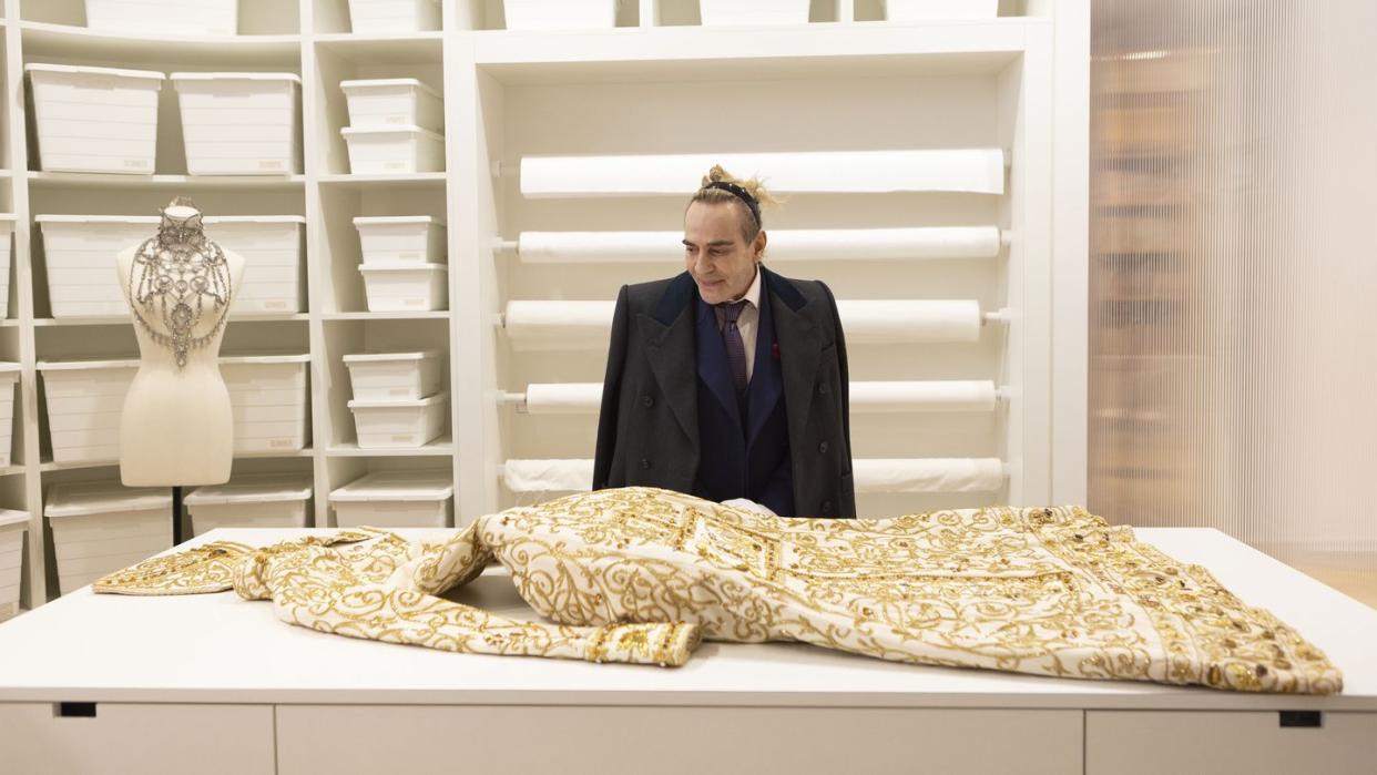 a person standing behind a table with a large snake on it