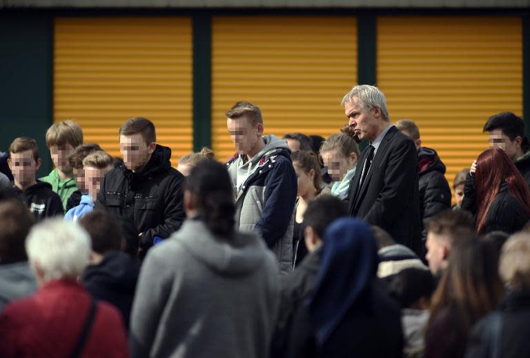 Koseph-Koenig-Gymnasium high school principal Ulrich Wessel and students observe a minute's silence for 16 students and two teachers killed in the Alps plane crash, in Haltern am See, Germany, on March 26, 2015