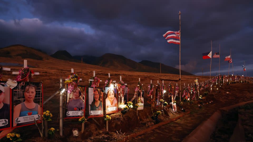 Pictures and crosses are displayed at a public hillside memorial to Lahaina wildfire victims on August 1, 2024 in Lahaina, Hawaii. August 8 marks the one-year anniversary of the Maui wildfires which killed 102 people and devastated the historic community of Lahaina in West Maui. - Mario Tama/Getty Images