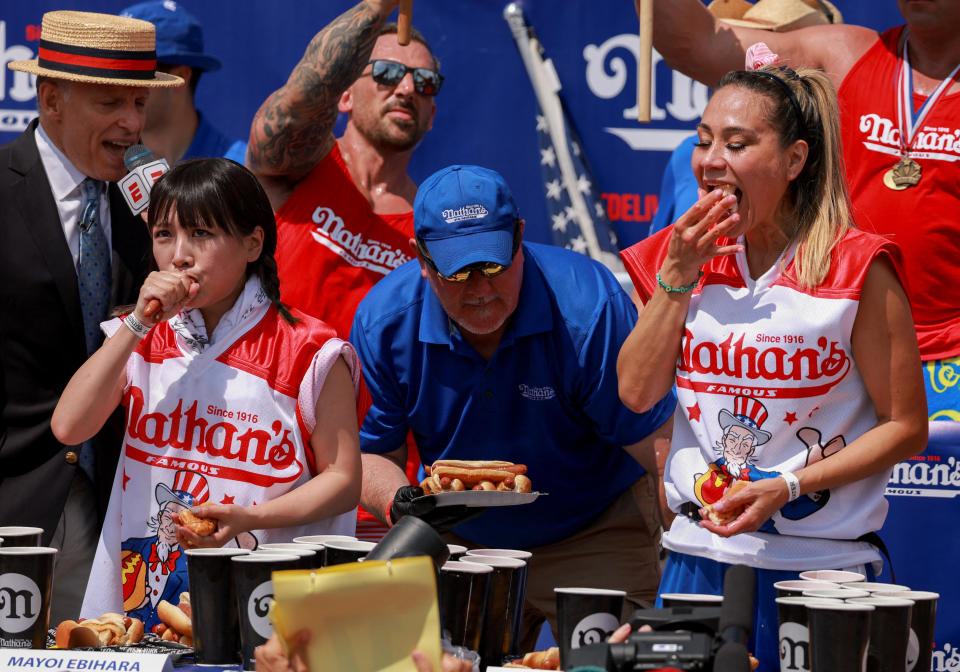 Mayoi Ebihara, left, and Miki Sudo compete in the Nathan's Famous Fourth of July International Hot Dog Eating Contest at Coney Island in New York City, July 4, 2023. / Credit: Reuters/Amr Alfiky