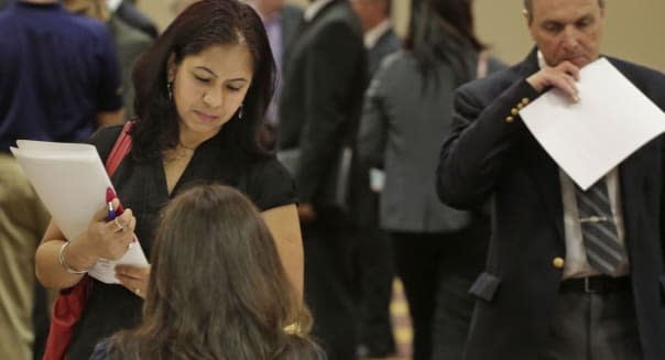 Economy (In this May 29, 2013 photo, job seeker Anu Vatal of Chicago, speaks with Patrice Tosi of BluePay, seated, during a care