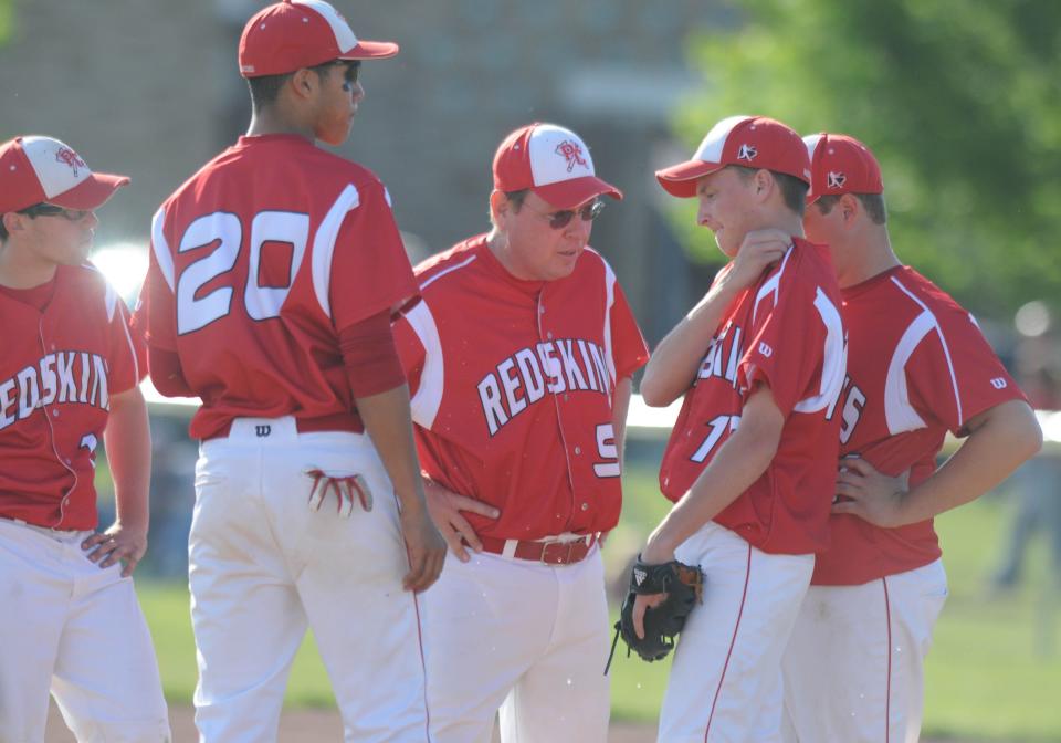 Port Clinton coach Tracy Bodi talks to players near the mound.