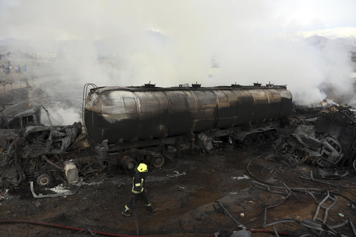 Firefighters work to extinguish a burning fuel tanker in Kabul, Afghanistan, Sunday, May 2, 2021. A fire roared through several fuel tankers on the northern edge of the Afghan capital late Saturday, injuring at least 10 people and plunging much of the city into darkness, officials said. (AP Photo/Rahmat Gul)
