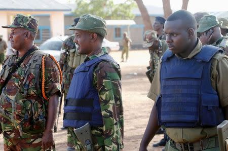 Kenya Defence Forces soldiers and policemen gather at the scene of an overnight attack on a residential complex in Soko Mbuzi village of Mandera town at the Kenya-Somalia border July 7, 2015. REUTERS/Stringer