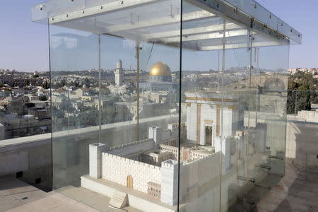 A model depicting the first Jewish temple, which once stood underneath the compound housing the Dome of the Rock (seen centre, in background) and Al-Aqsa mosque, is seen in Jerusalem's Old City June 2, 2015. REUTERS/Ammar Awad