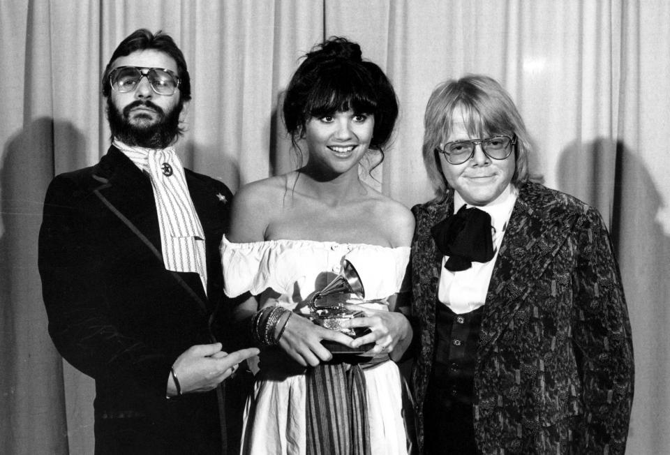 FILE - This Feb. 20, 1977 file photo shows singer Linda Ronstadt is flanked by Ringo Starr, left, and Paul Williams after she was named best pop singer for her "Hasten Down the Wind" at The 19th Annual Grammy Awards in Los Angeles. A documentary, “Linda Ronstadt: The Sound of My Voice,” will premiere on CNN on New Year's Day. (AP Photo)