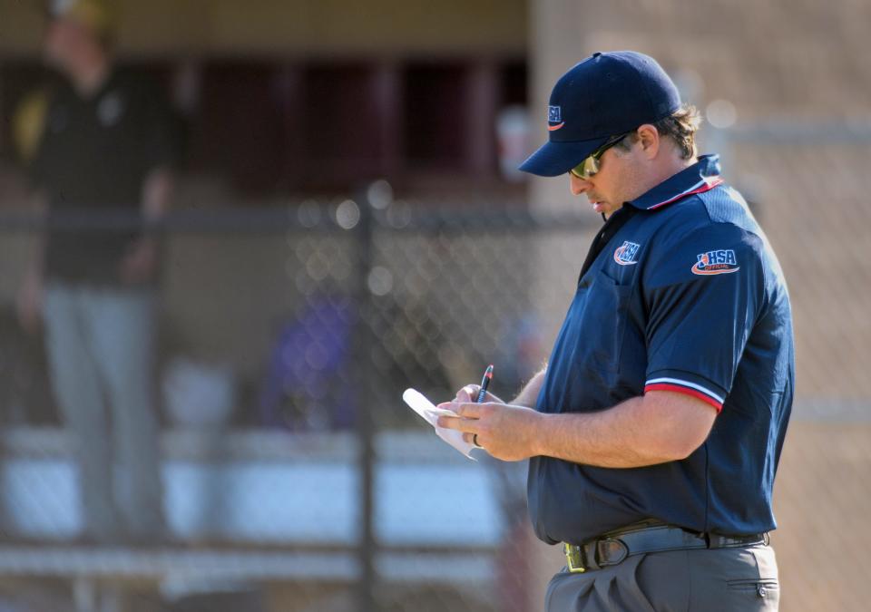 Umpire Zo Evans makes note of a pitching change during a recent baseball game between Dunlap and Canton at Dunlap High School.