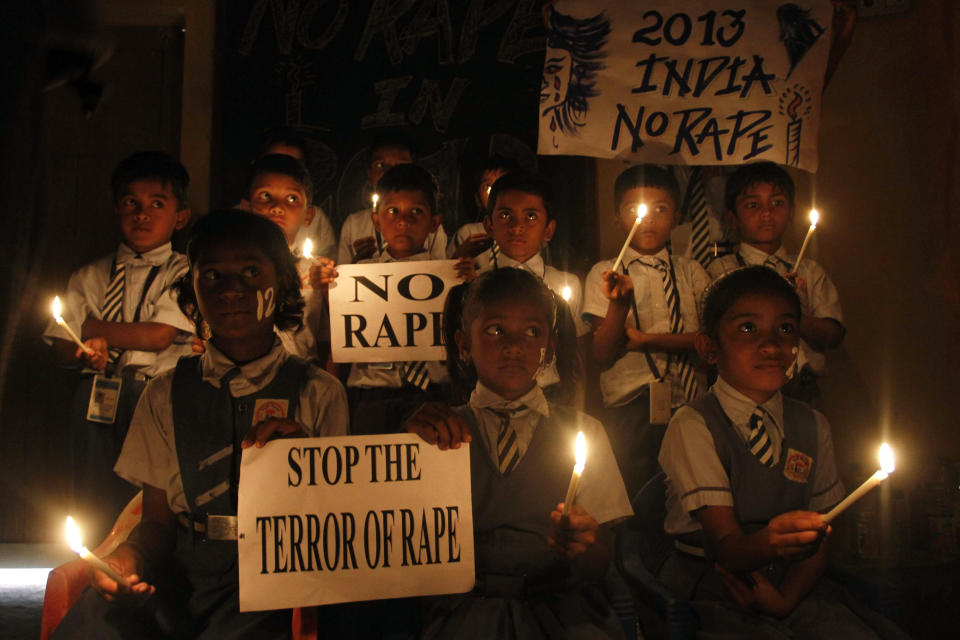 Indian schoolchildren hold candles and placards during a prayer ceremony in Ahmadabad, India, Monday, Dec. 31, 2012. (AP Photo/Ajit Solanki)