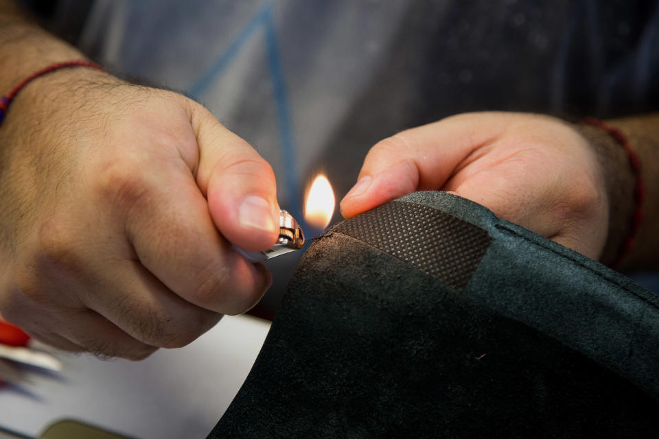 Angel Penaloza burns thread from a piece of leather for a handbag at Justin Paul, Inc., a luxury handbag manufacturer, in based in the Brooklyn Navy Yard, in New York, U.S., on Thursday, August 20, 2015. (Photo: Michael Nagle/Bloomberg)